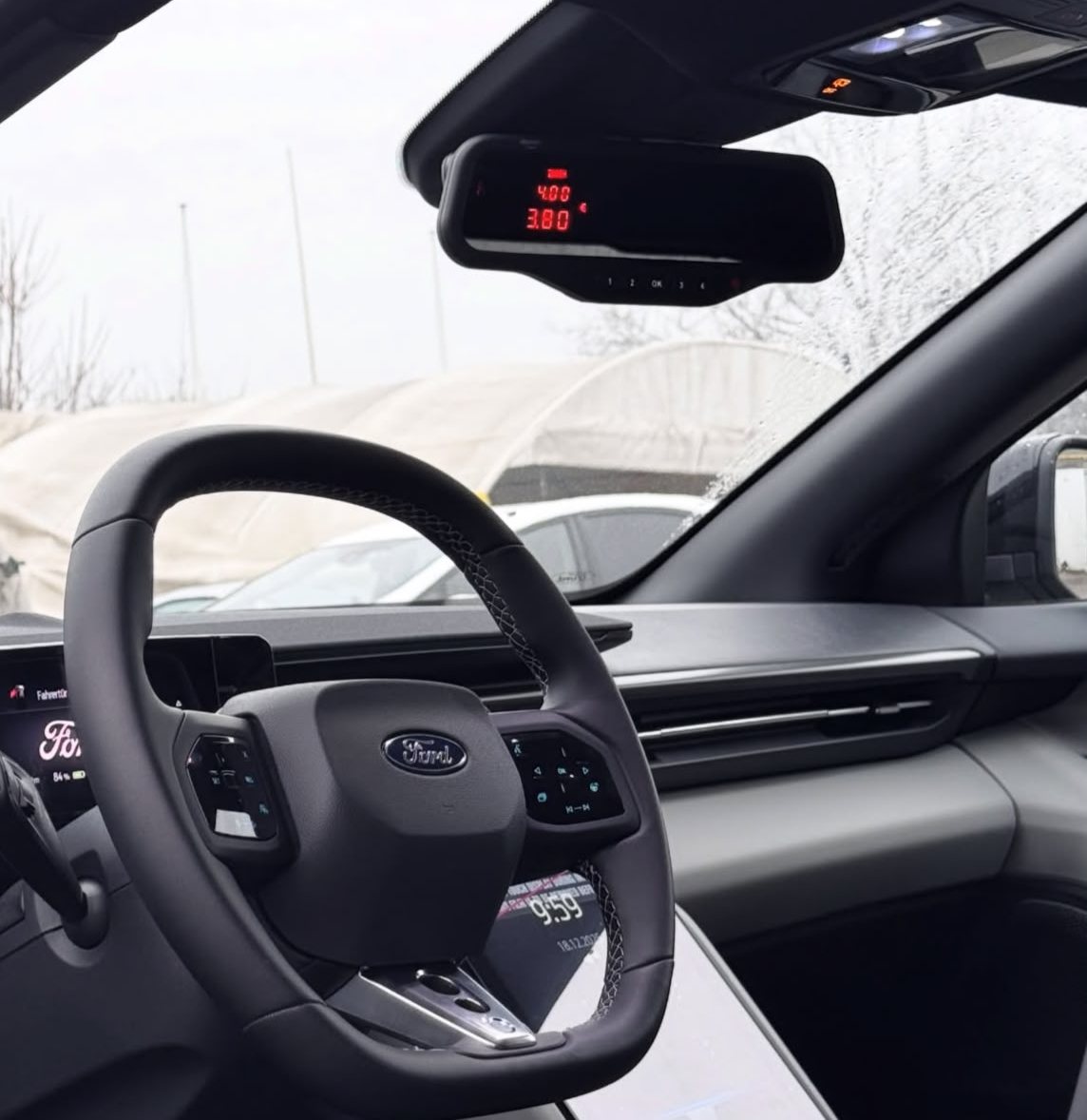 Alberen M12 Spiegeltaxameter im Innenspiegel eines Ford, die Anzeige zeigt den Fahrpreis